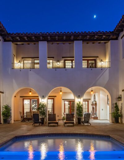 A home with a pool and patio at night.