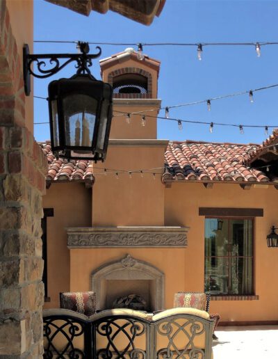 A patio with a fireplace and string lights.