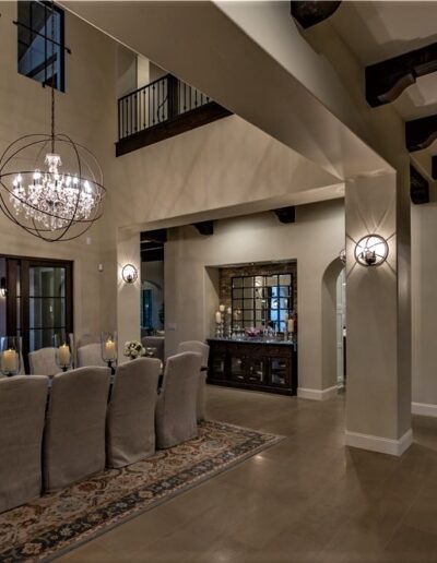 A dining room with a chandelier in the middle.