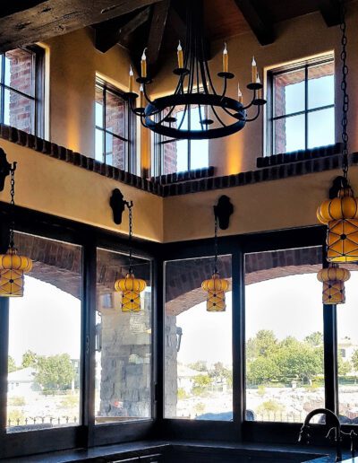 A kitchen with large windows and a sink.